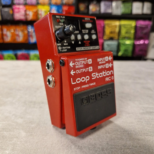 Pre-Owned Boss RC-3 Red Loop Station RC-3 guitar effects pedal on a gray surface with a colorful background