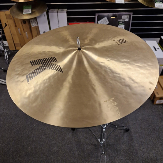 Pre-Owned Zildjian Cymbal on a stand in a store setting with boxes and shelves in the background