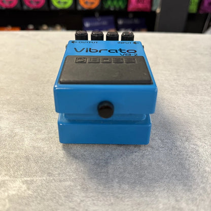 Pre-Owned Boss VB-2 Blue Vibrato VB-2 guitar effects pedal on a light gray surface with a blurred background.