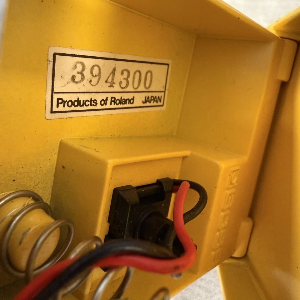 Pre-Owned Boss OD-1 Close-up of a yellow electrical component with a label indicating 'Products of Roland, Japan'.