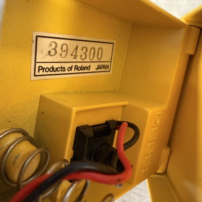 Pre-Owned Boss OD-1 Close-up of a yellow electrical component with a label indicating 'Products of Roland, Japan'.