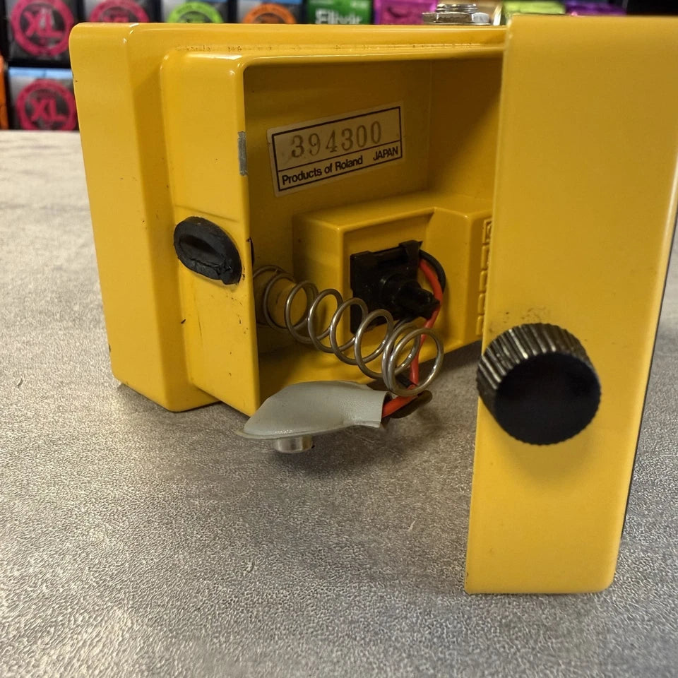 Pre-Owned Boss OD-1 Yellow mechanical device with springs and a label on a textured surface