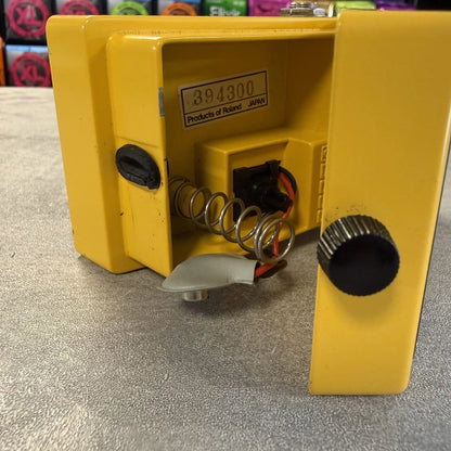 Pre-Owned Boss OD-1 Yellow mechanical device with springs and a label on a textured surface