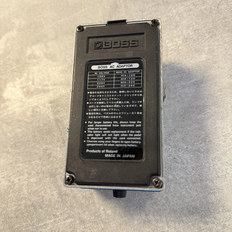 Pre-Owned Boss VB-2 Boss AC adapter on a textured gray surface