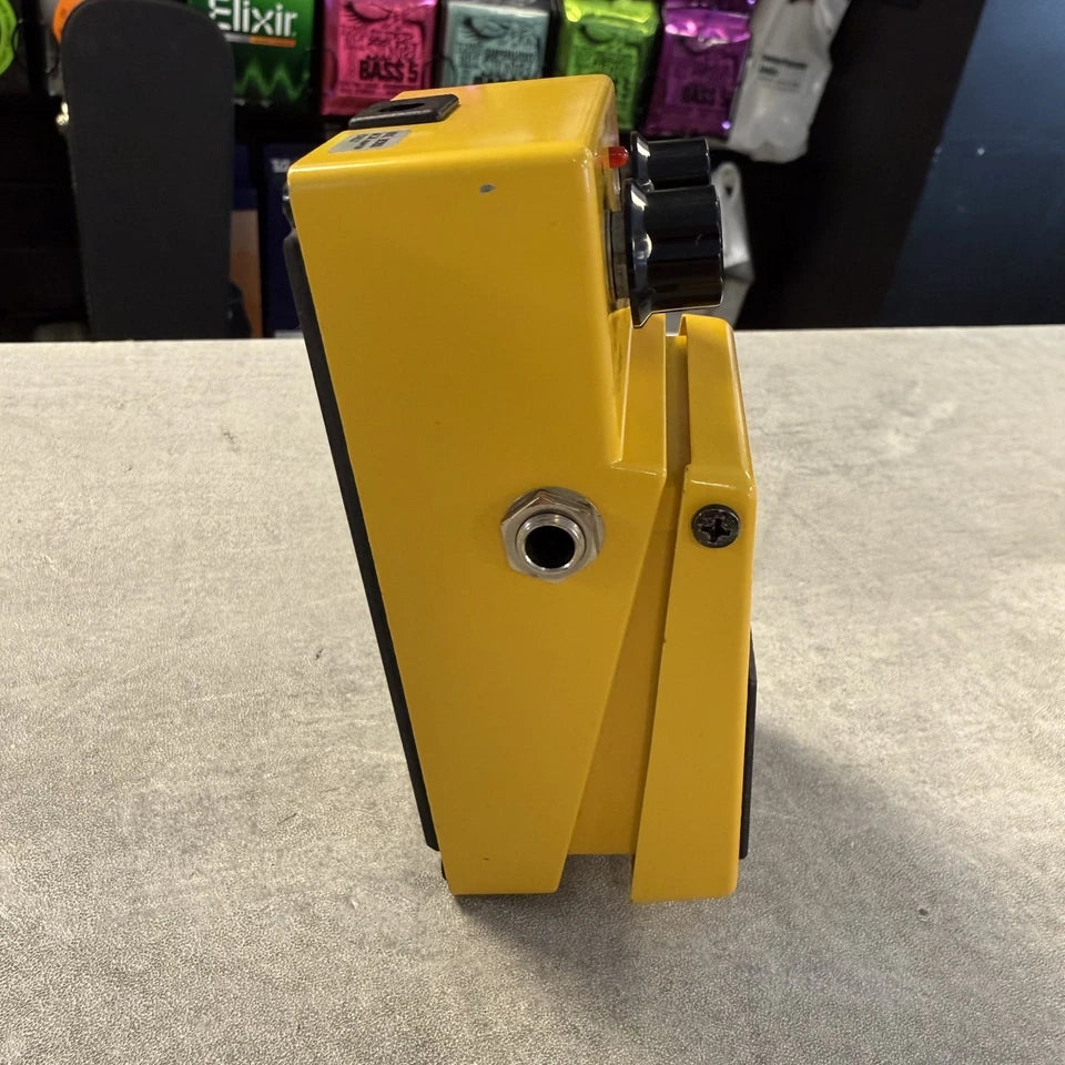 Pre-Owned Boss OD-1 Yellow metal component on a gray surface with blurred background