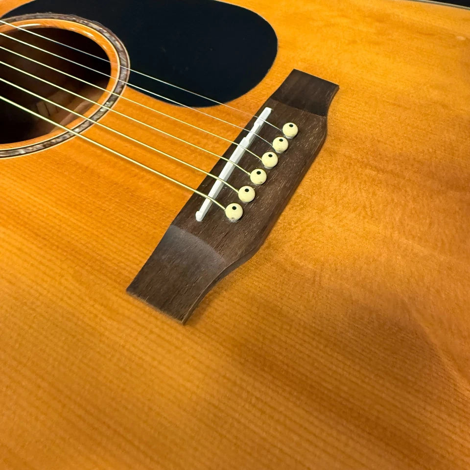 Pre-Owned Takamine EG530SC Close-up of an acoustic guitar's soundhole and bridge