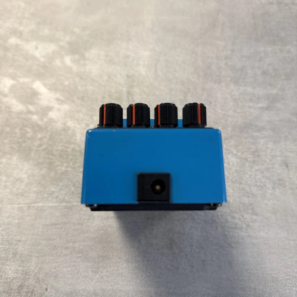 Pre-Owned Boss VB-2 Blue electronic component with black and red connectors on a gray background