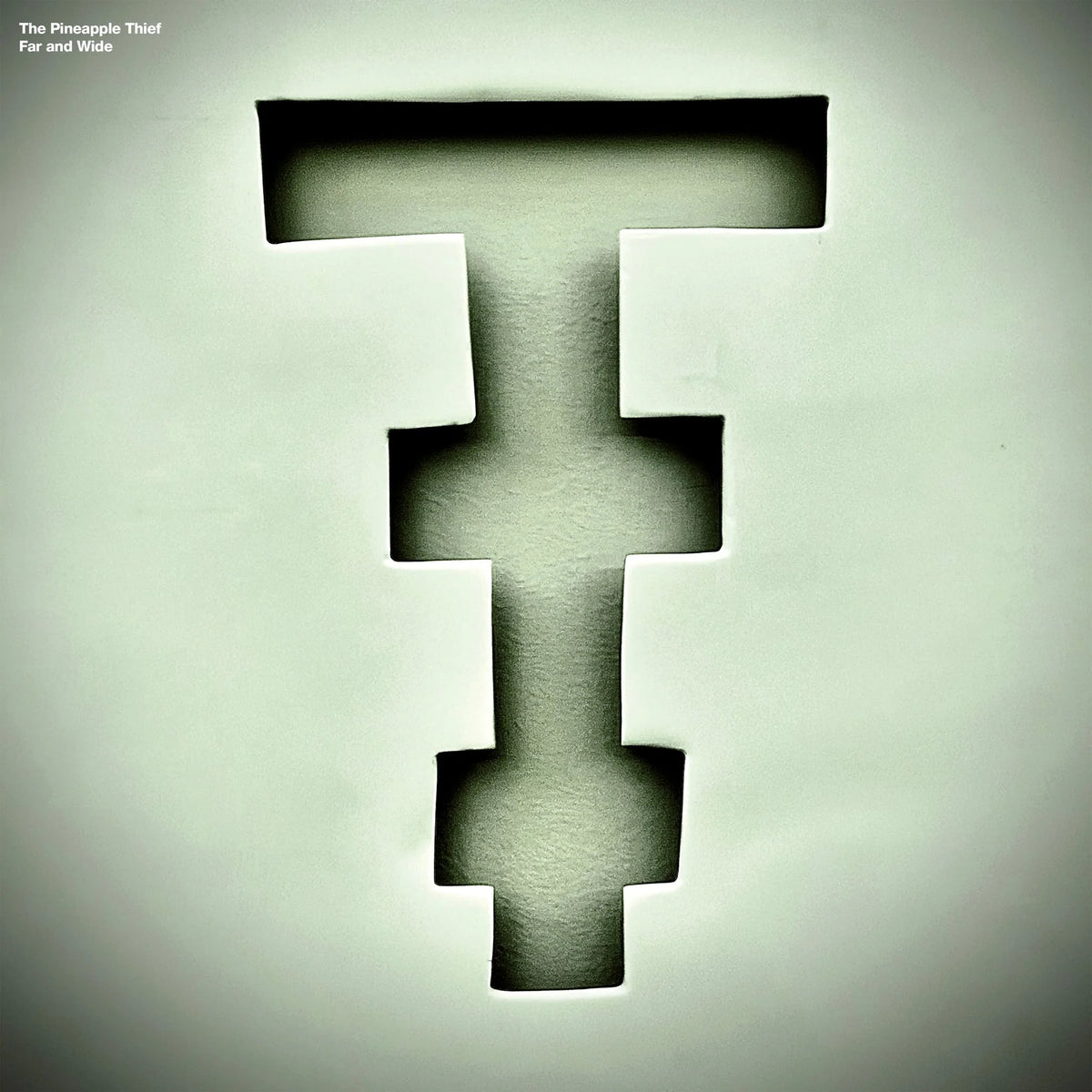 The Pineapple Thief - Far and Wide Vinyl Album cover art for 'Far and Wide' by The Pineapple Thief, featuring a large, stylized, pixelated letter 'T' in a dark olive-green hue against a matching textured off-white background.