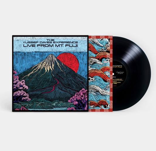 The Yussef Dayes Experience Vinyl record with a mountain-themed cover on a white background